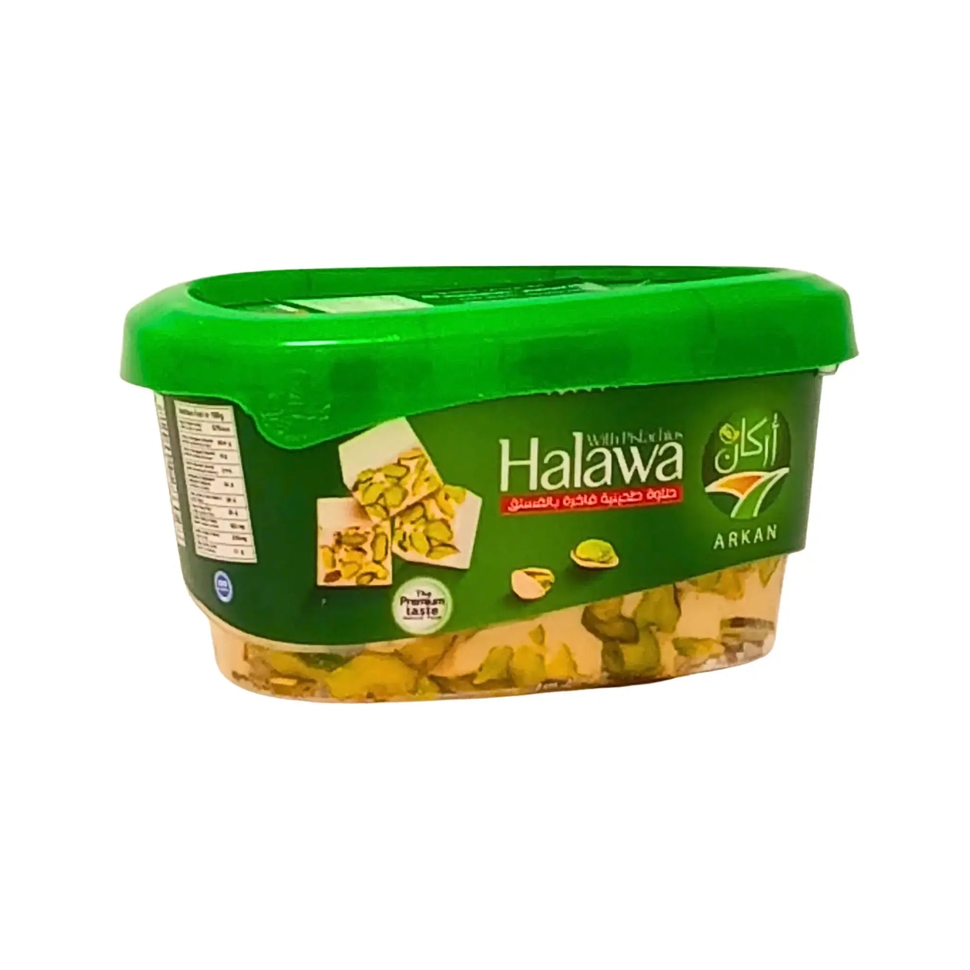 Plastburk med halawa med pistagenötter, grön lock och orientaliskt mönster på etiketten.