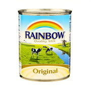 Burk med Rainbow mjölkkoncentrat original, med kossor på grön äng och regnbåge på etiketten.