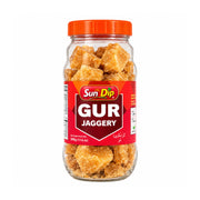 Burk med SunDip gur-jaggery, orange lock och sockerbitar i glas